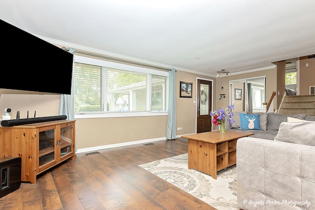 909 Aimtree Pl, Schaumburg, IL 60194 - living area with crown molding, wood finished floors, healthy amount of natural light, baseboards, and stairway