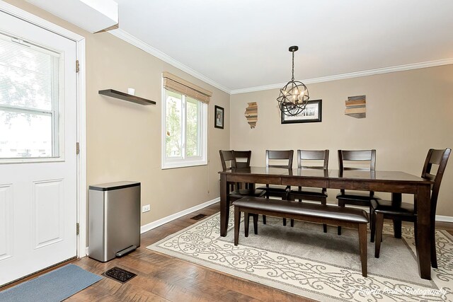 909 Aimtree Pl, Schaumburg, IL 60194 - dining area featuring baseboards, a chandelier, ornamental molding, and wood finished floors