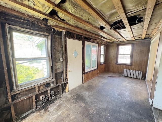 7514 S Rhodes Ave, Chicago, IL 60619 - unfurnished living room featuring radiator heating unit and wood walls