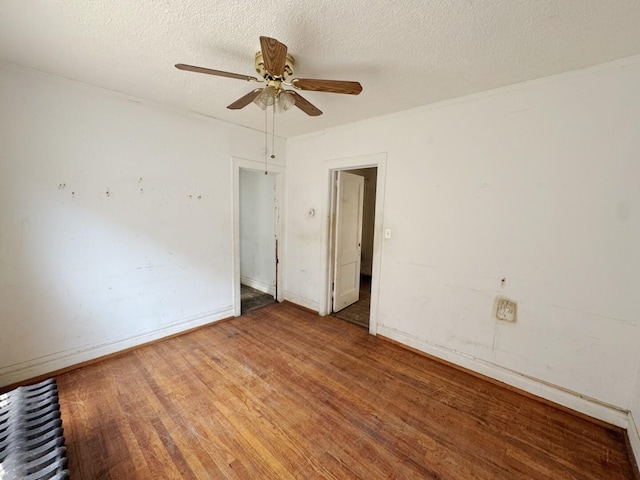 7514 S Rhodes Ave, Chicago, IL 60619 - unfurnished room with wood finished floors, ceiling fan, a textured ceiling, and baseboards