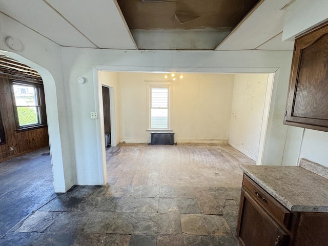 7514 S Rhodes Ave, Chicago, IL 60619 - unfurnished dining area with arched walkways and stone finish floors