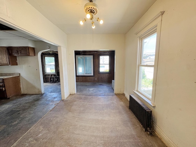 7514 S Rhodes Ave, Chicago, IL 60619 - hallway with radiator, concrete flooring, and arched walkways