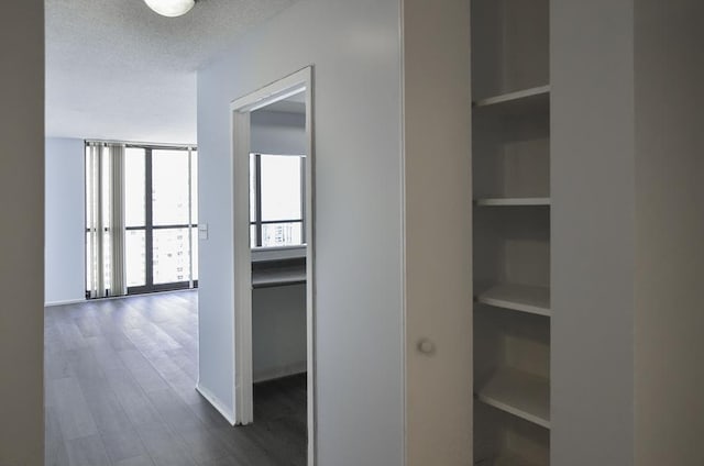 10 E Ontario St Unit 3311, Chicago, IL 60611 - hallway featuring dark wood-type flooring, built in features, a textured ceiling, and baseboards