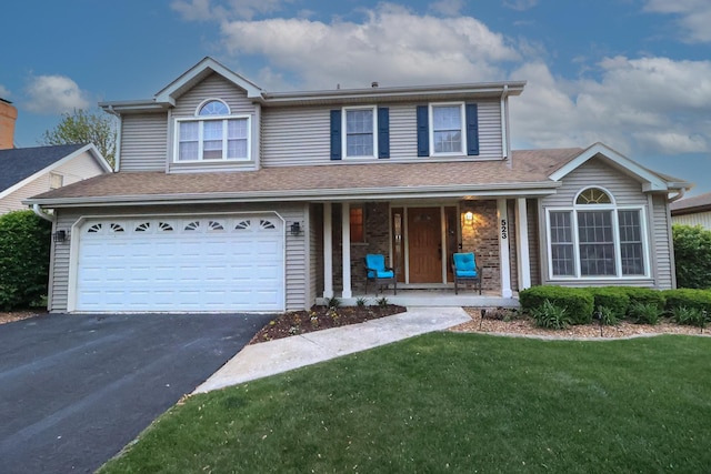 523 Jaquays St, Lockport, IL 60441 - traditional-style house featuring driveway, a front yard, a garage, a porch, and a shingled roof