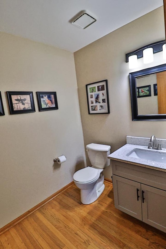 523 Jaquays St, Lockport, IL 60441 - bathroom featuring toilet, wood finished floors, vanity, and baseboards
