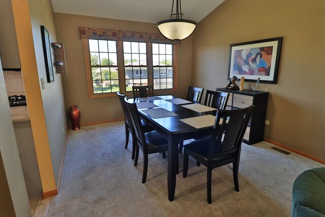 523 Jaquays St, Lockport, IL 60441 - dining area with light colored carpet, baseboards, and lofted ceiling