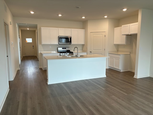 2280 Elderberry Ct, Wonder Lake, IL 60097 - kitchen with stainless steel appliances, dark wood-style floors, a center island with sink, baseboards, and a sink