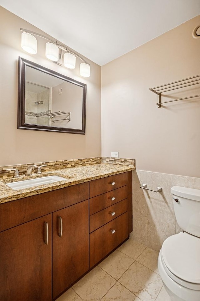 10 E Ontario St Unit 3609, Chicago, IL 60611 - bathroom featuring tile walls, vanity, toilet, marble finish flooring, and a wainscoted wall