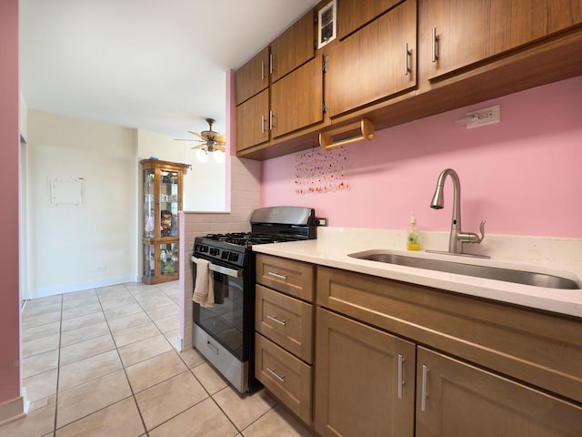 33 N Main St Unit 4J, Lombard, IL 60148 - kitchen with stainless steel gas stove, light tile patterned floors, a ceiling fan, light countertops, and brown cabinetry