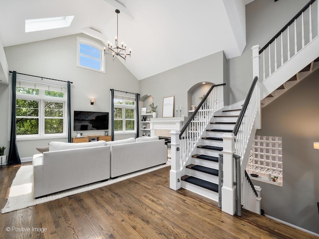 1344 W George St Unit 3, Chicago, IL 60657 - living room featuring high vaulted ceiling, a skylight, wood finished floors, stairs, and a chandelier
