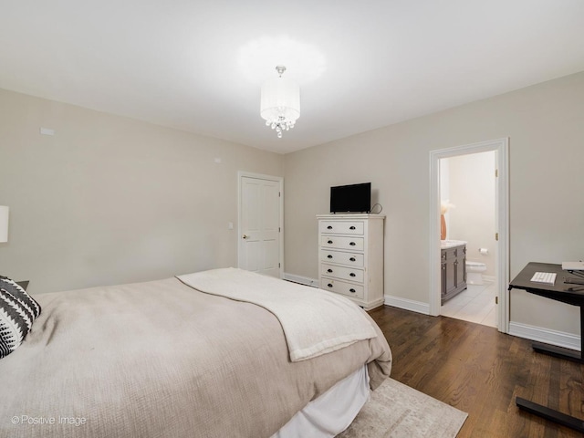 1344 W George St Unit 3, Chicago, IL 60657 - bedroom featuring wood finished floors, a chandelier, baseboards, and ensuite bath