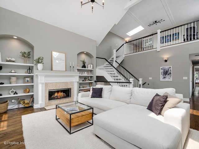 1344 W George St Unit 3, Chicago, IL 60657 - living room featuring high vaulted ceiling, wood finished floors, built in features, a fireplace with flush hearth, and stairs