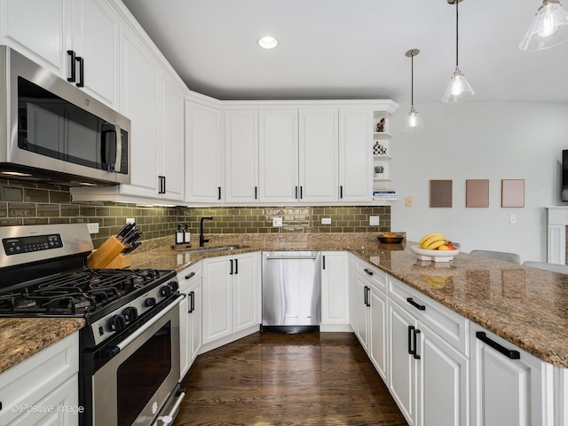 1344 W George St Unit 3, Chicago, IL 60657 - kitchen with appliances with stainless steel finishes, a sink, a peninsula, white cabinetry, and tasteful backsplash