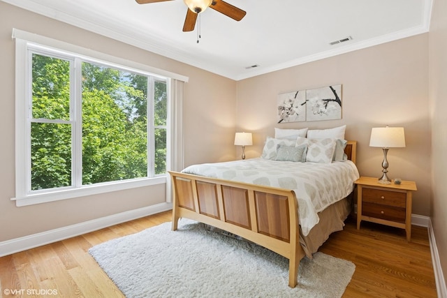 1513 W Highland Ave, Chicago, IL 60660 - bedroom with multiple windows, ornamental molding, light wood finished floors, and a ceiling fan
