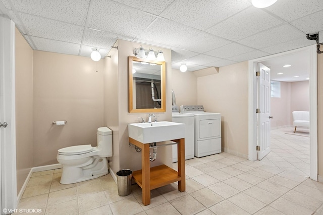 1513 W Highland Ave, Chicago, IL 60660 - bathroom featuring washing machine and dryer, a drop ceiling, and tile patterned flooring