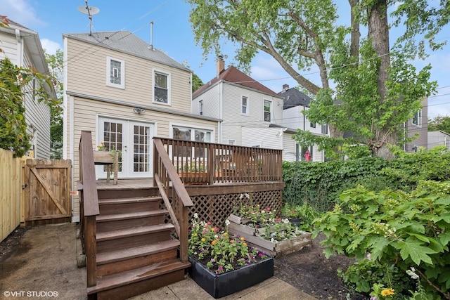 1513 W Highland Ave, Chicago, IL 60660 - back of property with french doors, a deck, and a vegetable garden