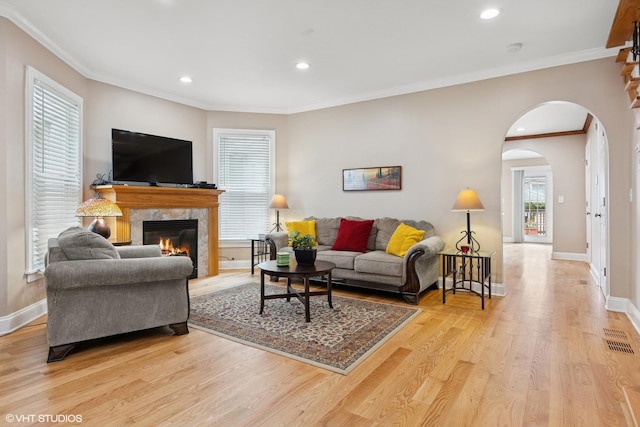 1513 W Highland Ave, Chicago, IL 60660 - living room featuring arched walkways, a fireplace, light wood-type flooring, recessed lighting, and ornamental molding