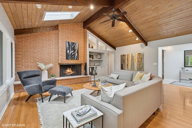 1543 Shawnee Trl, Riverwoods, IL 60015 - living room with a skylight, ceiling fan, a brick fireplace, wood finished floors, and a wooden ceiling with exposed beams