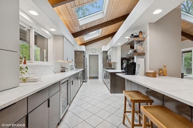 1543 Shawnee Trl, Riverwoods, IL 60015 - kitchen with a skylight, wine cooler, wood ceiling, open shelves, and recessed lighting