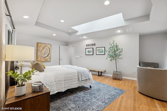 1543 Shawnee Trl, Riverwoods, IL 60015 - bedroom featuring a skylight, light wood-style floors, recessed lighting, and a raised ceiling