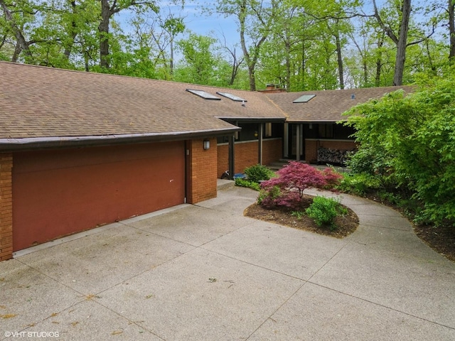 1543 Shawnee Trl, Riverwoods, IL 60015 - view of front of property featuring brick siding, a shingled roof, an attached garage, concrete driveway, and a chimney