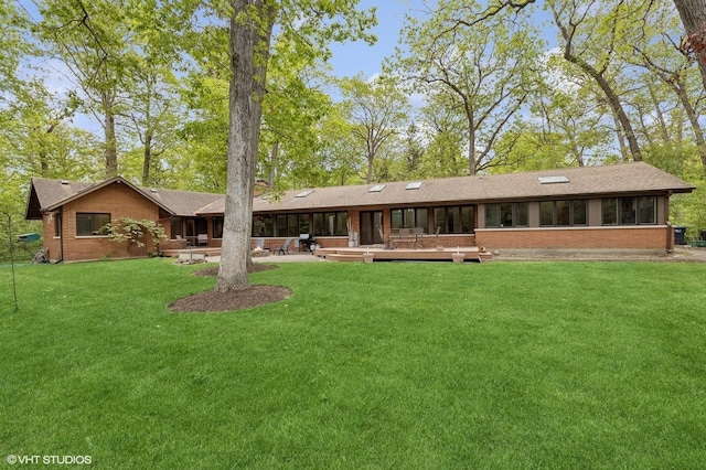 1543 Shawnee Trl, Riverwoods, IL 60015 - back of property with brick siding, a lawn, and a patio