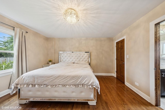 5112 N Canfield Ave, Norridge, IL 60706 - bedroom with baseboards, wood finished floors, and a chandelier