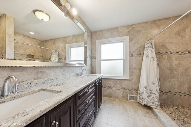 5112 N Canfield Ave, Norridge, IL 60706 - full bath featuring tiled shower, tile walls, and double vanity