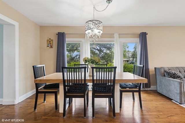 5112 N Canfield Ave, Norridge, IL 60706 - dining room with a chandelier, wood finished floors, and baseboards