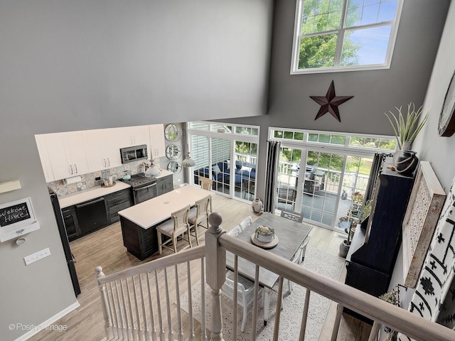 1016 Hummingbird Way, Bartlett, IL 60103 - living area with a towering ceiling, light wood-style floors, and baseboards