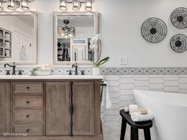 1016 Hummingbird Way, Bartlett, IL 60103 - full bath featuring tile walls, wainscoting, double vanity, and a soaking tub