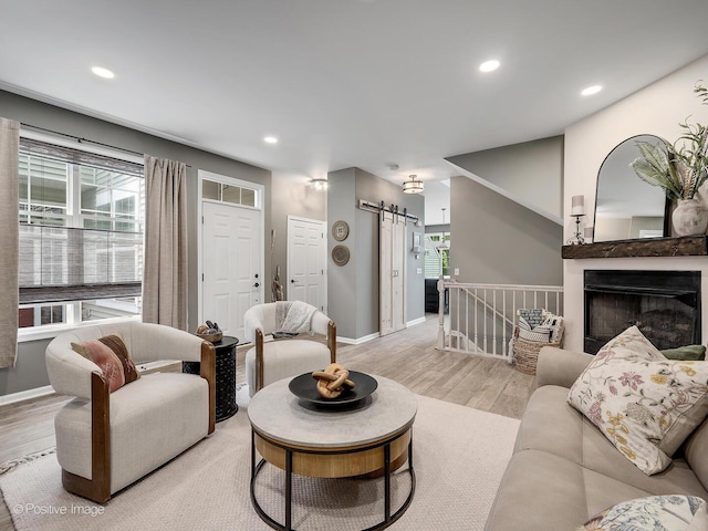 1016 Hummingbird Way, Bartlett, IL 60103 - living room with wood finished floors, baseboards, a barn door, and recessed lighting