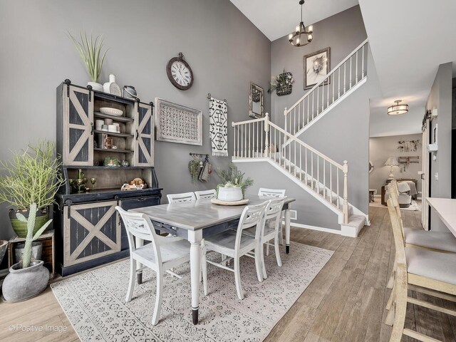 1016 Hummingbird Way, Bartlett, IL 60103 - dining space with wood finished floors, stairway, a chandelier, and baseboards