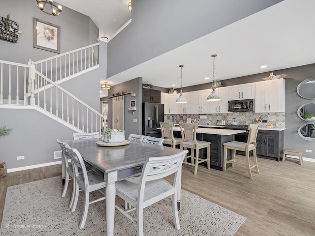 1016 Hummingbird Way, Bartlett, IL 60103 - dining area with stairs, light wood-type flooring, recessed lighting, and baseboards