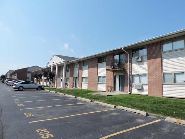 703 E Fullerton Ave Unit 1-110, Glendale Heights, IL 60139 - view of property featuring uncovered parking