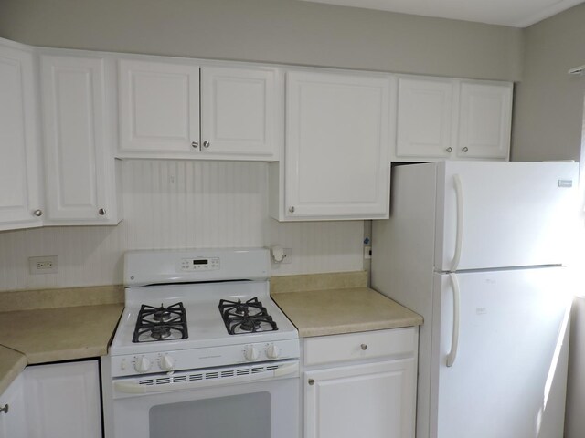 703 E Fullerton Ave Unit 1-110, Glendale Heights, IL 60139 - kitchen with white appliances, white cabinetry, and light countertops
