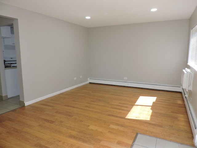 703 E Fullerton Ave Unit 1-110, Glendale Heights, IL 60139 - unfurnished room with light wood-style floors, a baseboard radiator, recessed lighting, and baseboard heating