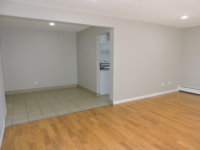 703 E Fullerton Ave Unit 1-110, Glendale Heights, IL 60139 - empty room with a baseboard radiator, light wood-style flooring, and recessed lighting