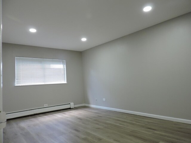 703 E Fullerton Ave Unit 1-110, Glendale Heights, IL 60139 - empty room with a baseboard radiator, wood finished floors, and recessed lighting