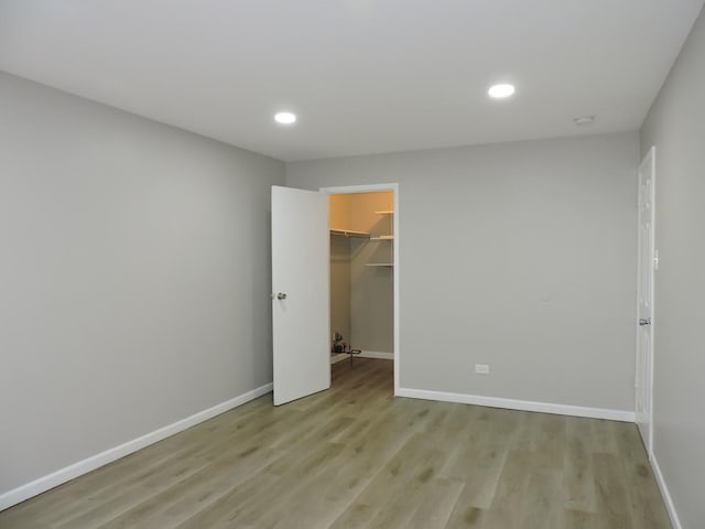 703 E Fullerton Ave Unit 1-110, Glendale Heights, IL 60139 - unfurnished bedroom with light wood-type flooring, recessed lighting, a spacious closet, and a closet