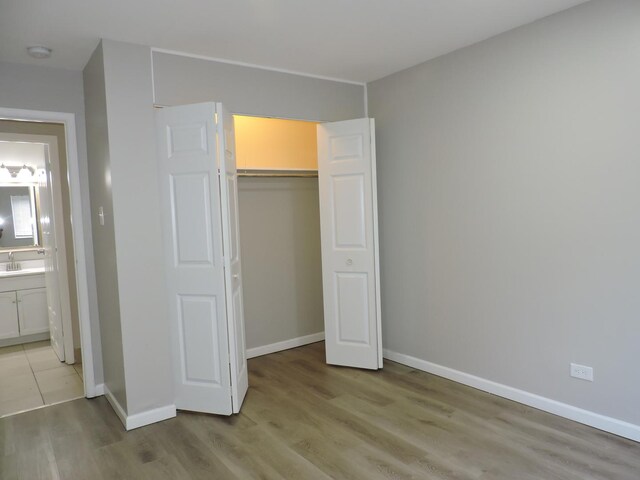 703 E Fullerton Ave Unit 1-110, Glendale Heights, IL 60139 - unfurnished bedroom featuring light wood-type flooring and a closet