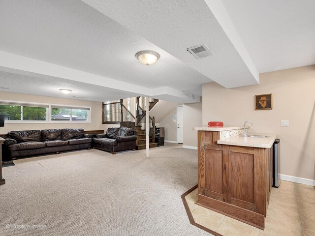 625 N Dupage Ave, Addison, IL 60101 - living area with bar with sink, stairs, light carpet, baseboards, and a textured ceiling