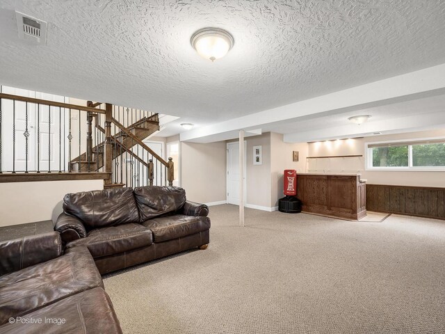 625 N Dupage Ave, Addison, IL 60101 - carpeted living area featuring bar area, a textured ceiling, stairway, and baseboards
