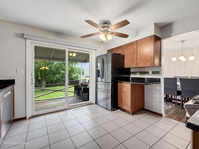 625 N Dupage Ave, Addison, IL 60101 - kitchen featuring fridge with ice dispenser, dark countertops, brown cabinetry, a chandelier, and ceiling fan