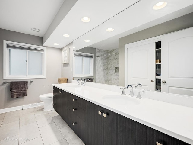 625 N Dupage Ave, Addison, IL 60101 - bathroom with baseboards, recessed lighting, double vanity, toilet, and a tile shower
