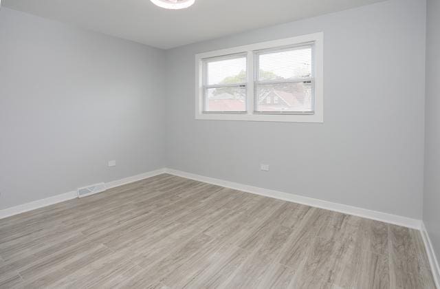 615 E 101st Pl, Chicago, IL 60628 - unfurnished room with light wood-style flooring and baseboards