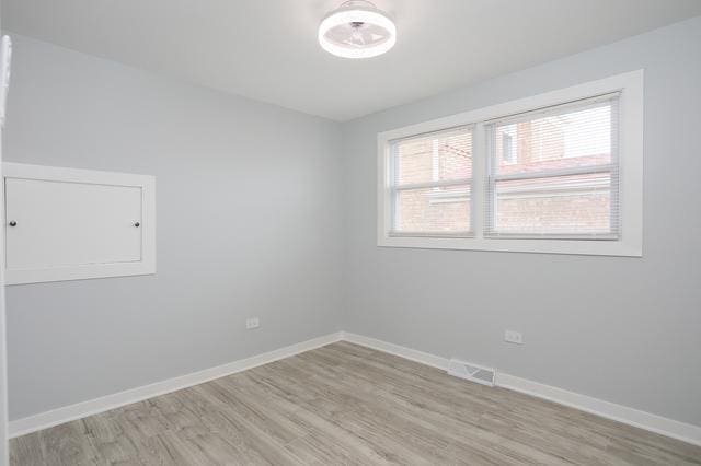 615 E 101st Pl, Chicago, IL 60628 - empty room with light wood-type flooring and baseboards