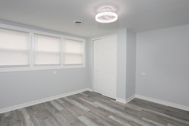 615 E 101st Pl, Chicago, IL 60628 - unfurnished bedroom featuring wood finished floors, a closet, and baseboards