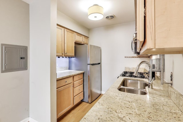 1415 W Lunt Ave Unit 203, Chicago, IL 60626 - kitchen featuring a sink, freestanding refrigerator, electric panel, light brown cabinets, and light wood finished floors