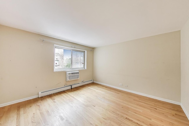 1415 W Lunt Ave Unit 203, Chicago, IL 60626 - empty room with a baseboard heating unit, light wood-style flooring, a wall mounted air conditioner, and baseboards